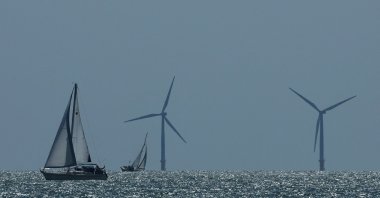 A yacht sails in front of an offshore wind farm, seen from Walton-on-the-Naze, U.K., Aug. 13, 2024. (Reuters Photo)