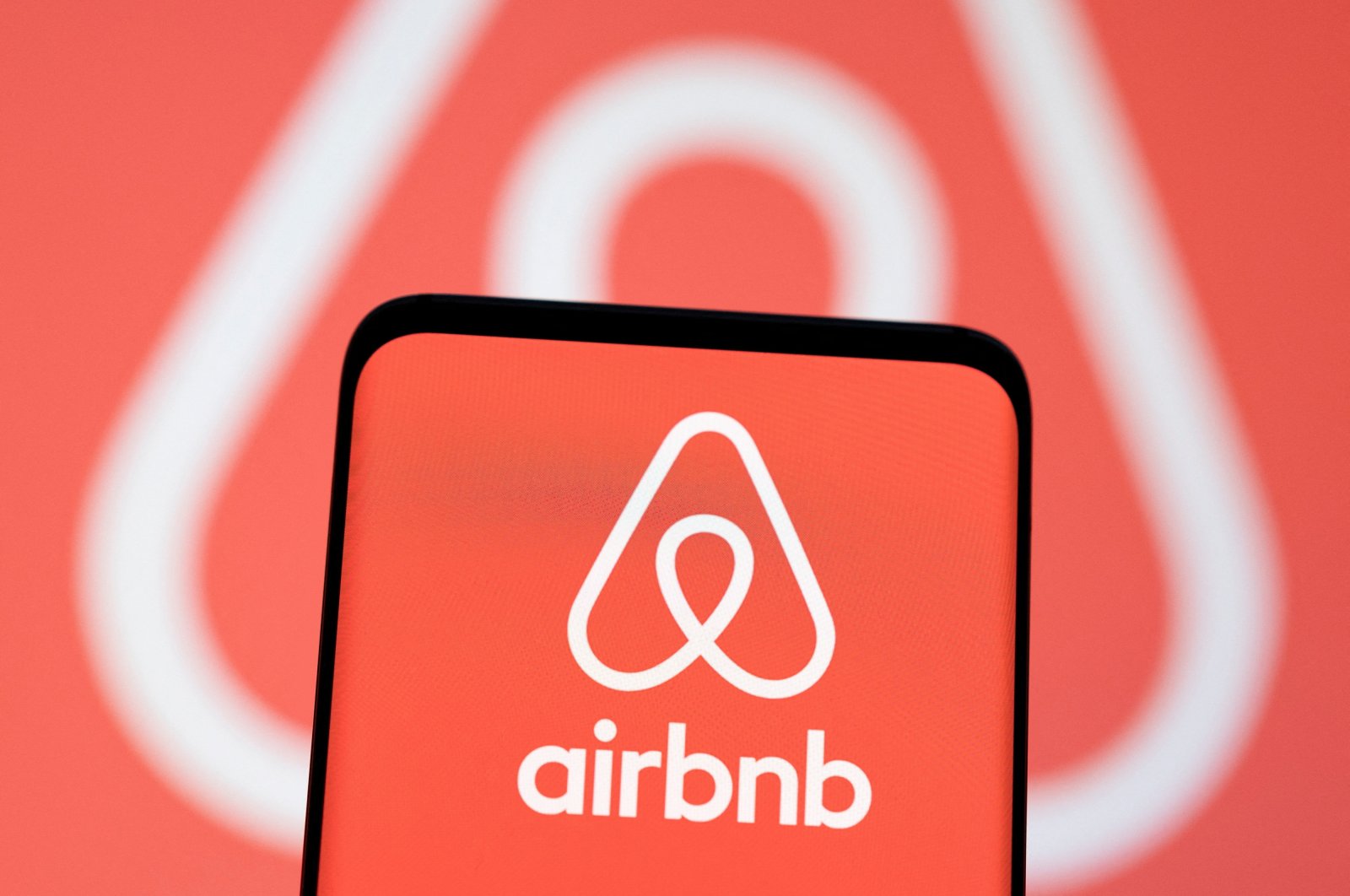 The Airbnb logo is seen displayed in this illustration from May 3, 2022. (Reuters Photo)