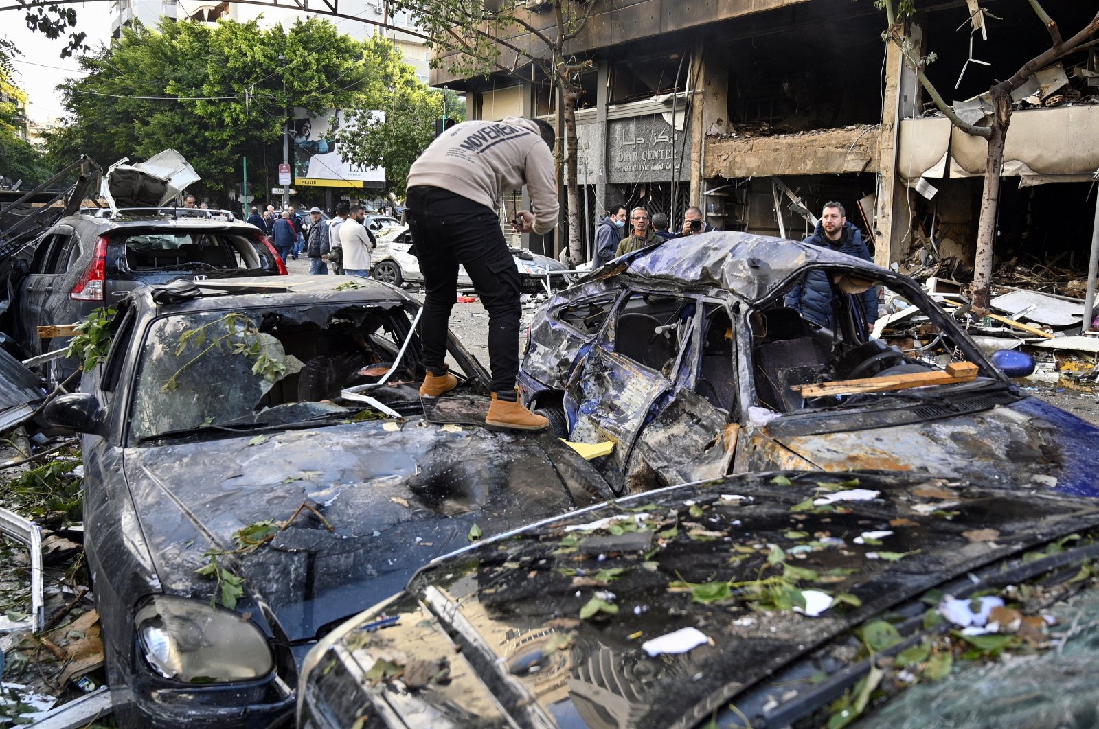 A man inspects his damaged car following an Israeli airstrike in Mar Elias Street, Beirut, Lebanon, Nov. 18, 2024. (EPA Photo)