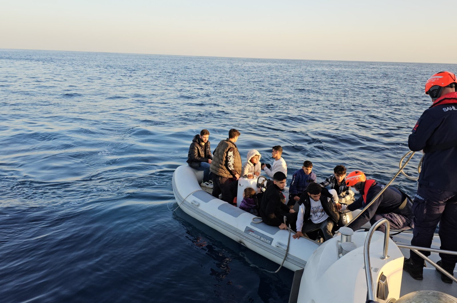 Coast guard officers escort an intercepted group of irregular migrants in Aydın, western Türkiye, Nov. 4, 2024. (İHA Photo)