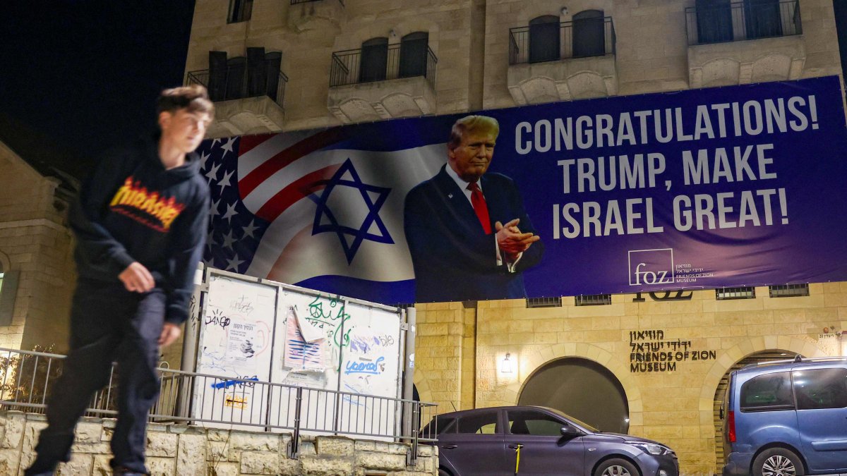 A youth skateboards under a banner congratulating U.S. President-elect Donald Trump on winning the U.S. presidential election, Jerusalem, Israel, Nov. 7, 2024. (AFP Photo)