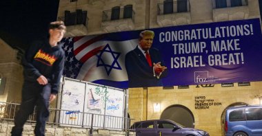A youth skateboards under a banner congratulating U.S. President-elect Donald Trump on winning the U.S. presidential election, Jerusalem, Israel, Nov. 7, 2024. (AFP Photo)