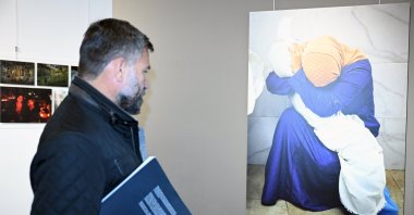 A visitor examines a photograph at the Istanbul Photo Awards in Brussels, Belgium, Nov. 4, 2024. (AA Photo)