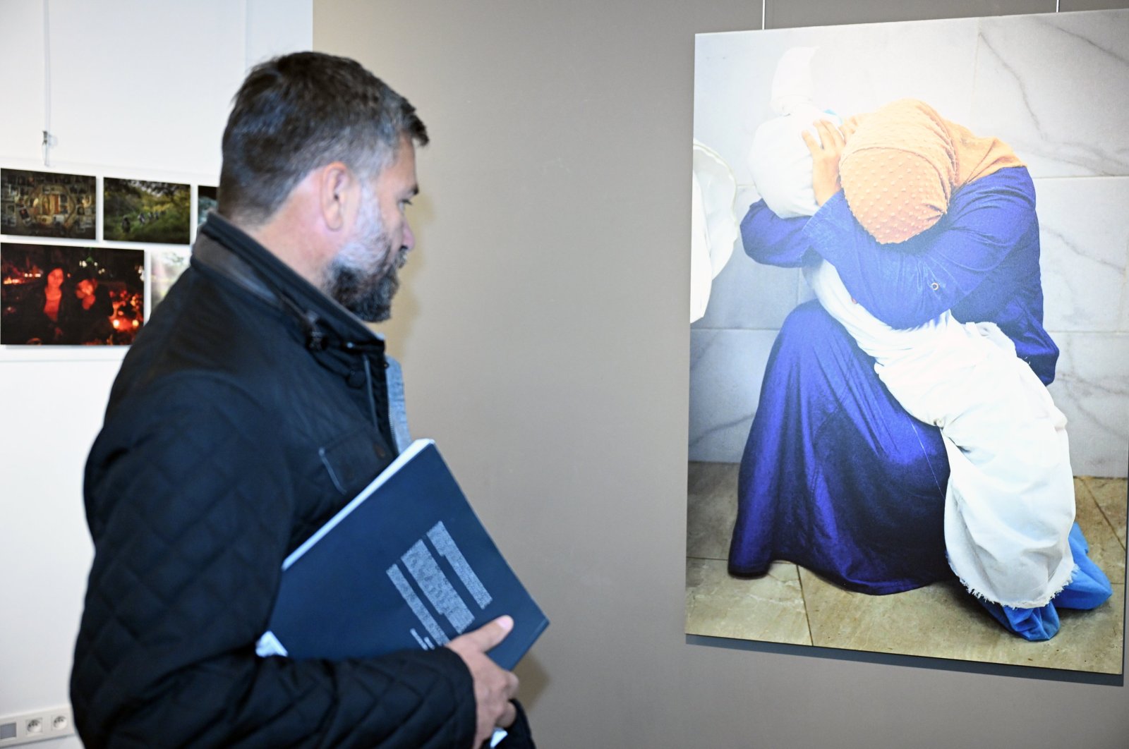 A visitor examines a photograph at the Istanbul Photo Awards in Brussels, Belgium, Nov. 4, 2024. (AA Photo)