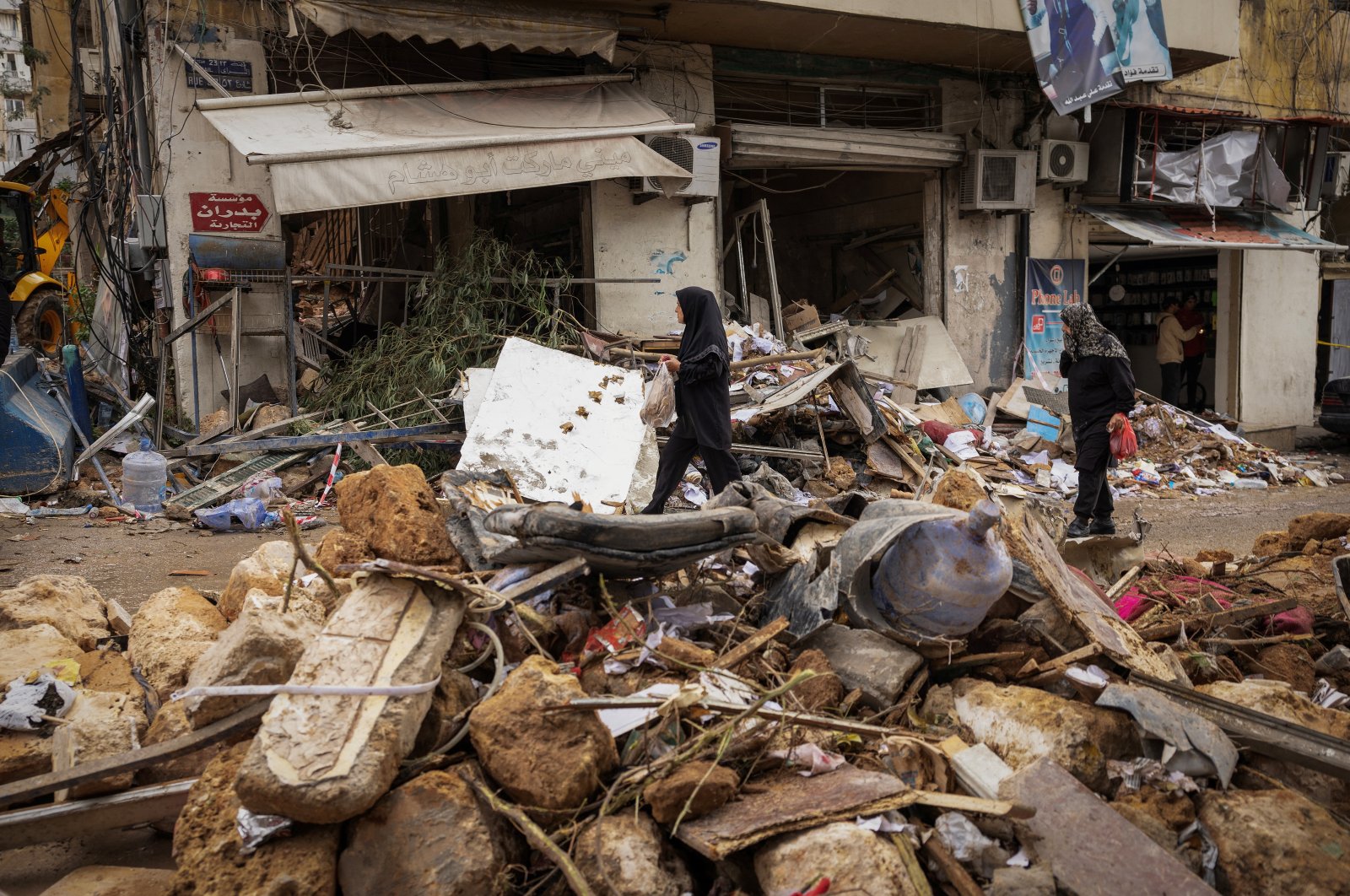 Women walk past a damaged building in the aftermath of an Israeli strike in the Zuqaq al-Blat area, Beirut, Lebanon, Nov. 19, 2024. (Reuters Photo)