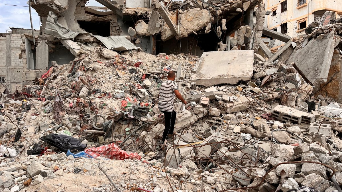 A Palestinian man searches for clothes through the rubble of a house destroyed by Israeli attacks on Khan Younis, southern Gaza Strip, Nov. 18, 2024. (Reuters Photo)