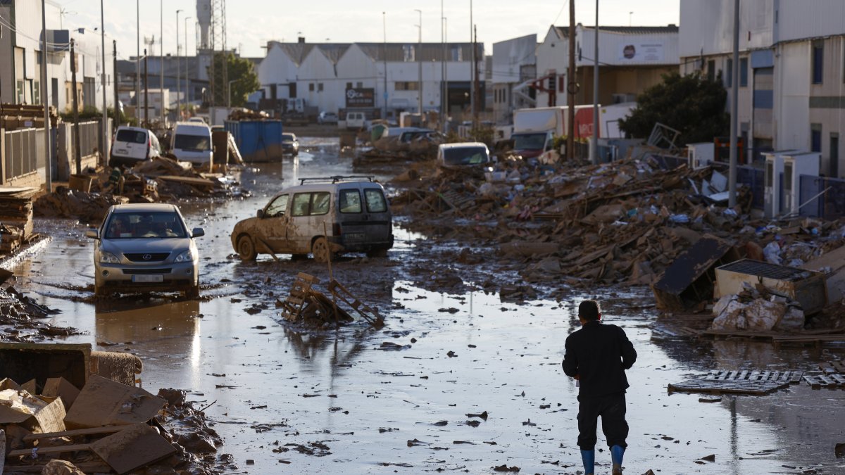 A person walks along a muddy street in the flood-hit city of Catarroja, Valencia, Spain, Nov. 11, 2024. (EPA Photo)