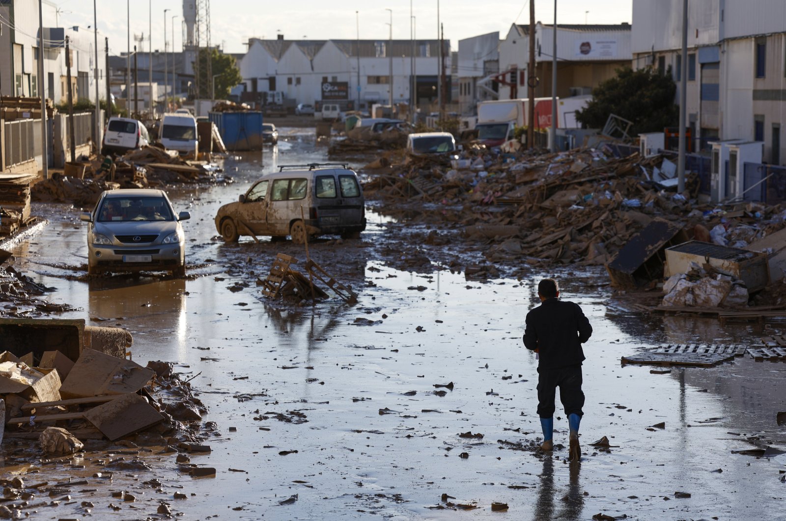 A person walks along a muddy street in the flood-hit city of Catarroja, Valencia, Spain, Nov. 11, 2024. (EPA Photo)