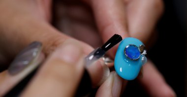 Japanese manicurist Naomi Arimoto decorates a false nail with a decorative nail tip using plastic waste at her salon in Chigasaki, Kanagawa Prefecture, Japan, Oct. 21, 2024. (Reuters Photo)