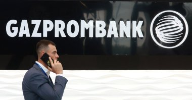 A man walks past the logo of Gazprombank during the Saint Petersburg International Gas Forum in Saint Petersburg, Russia, Sept. 15, 2022. (Reuters File Photo)