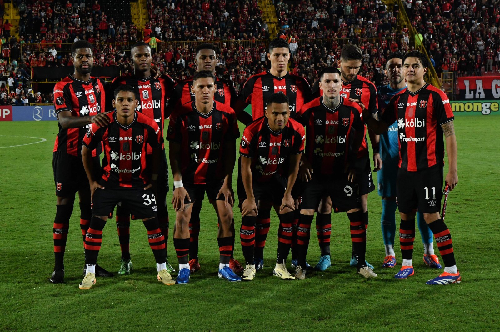 Alajuelense players pose for a team photo ahead of the Concacaf Central American Cup second leg semifinal match against Antigua GFC, at the Alejandro Morera Soto stadium, Alajuela, Costa Rica, Oct. 30, 2024. (AFP Photo)