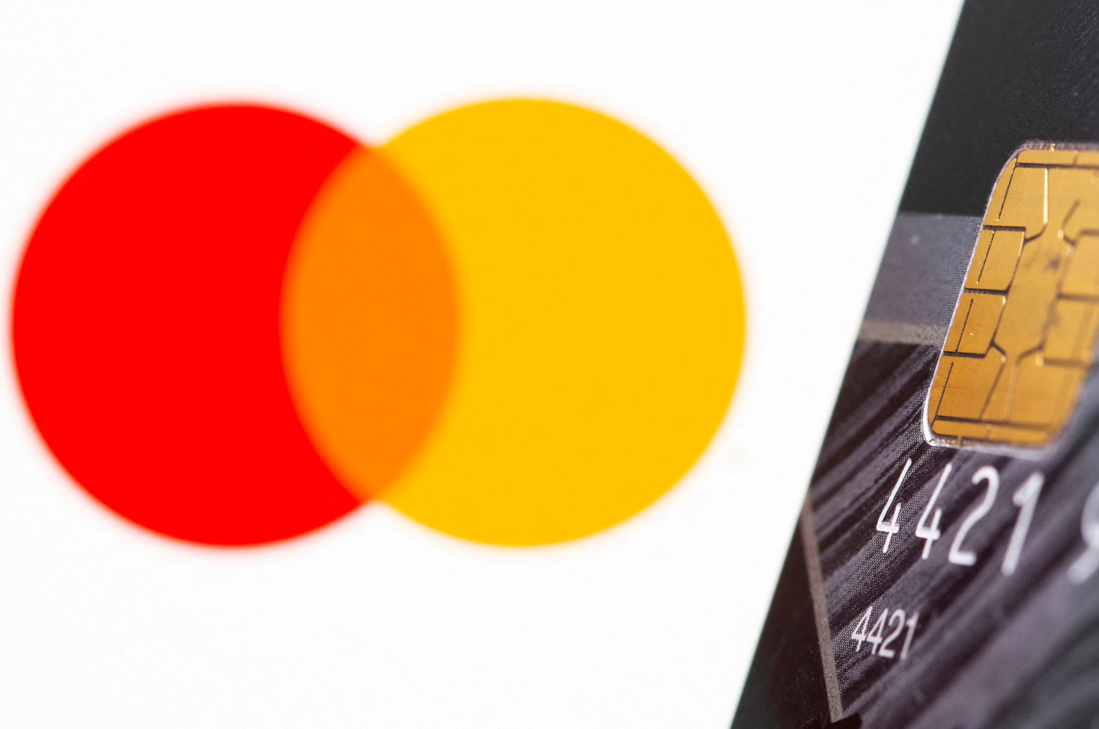 A credit card in front of the displayed Mastercard logo in this illustration taken on July 15, 2021. (Reuters Photo)