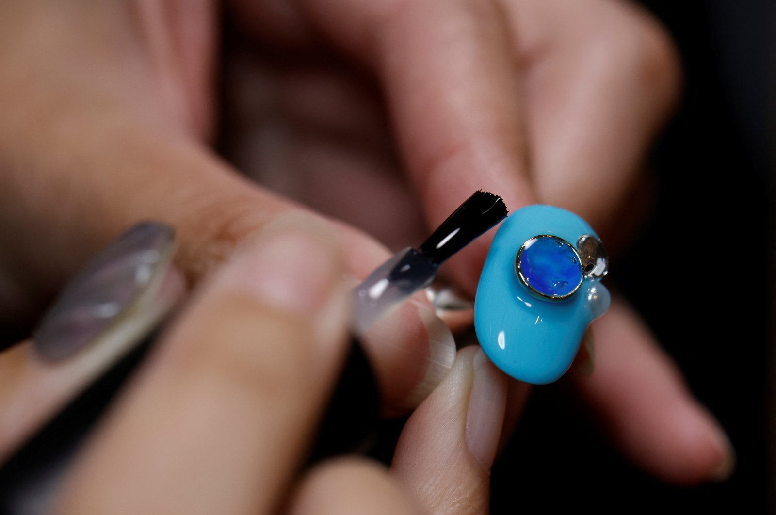 Japanese manicurist Naomi Arimoto decorates a false nail with a decorative nail tip using plastic waste at her salon in Chigasaki, Kanagawa Prefecture, Japan, Oct. 21, 2024. (Reuters Photo)