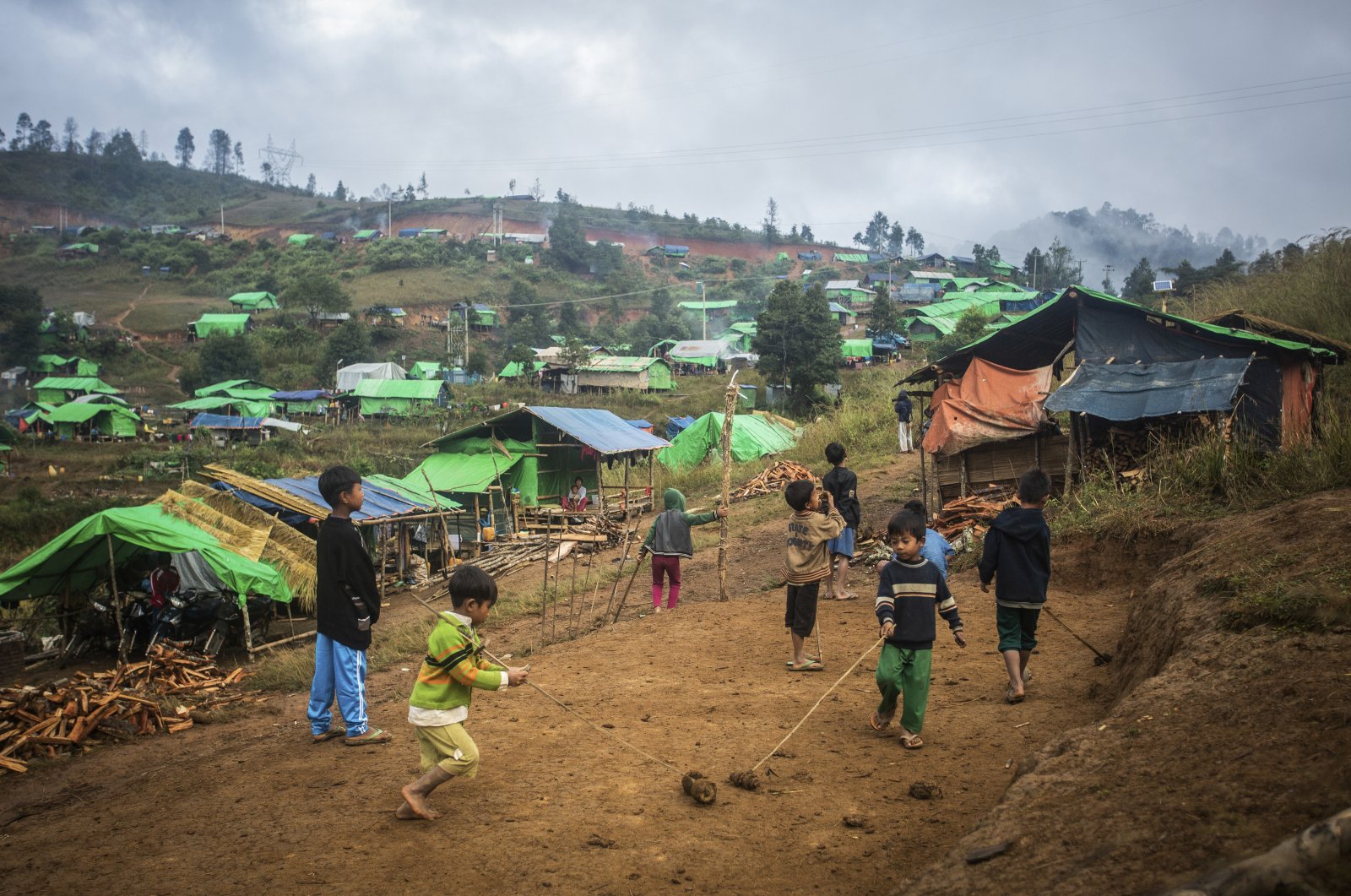 Children playing near IDPs camp in Demoso Township, Kayah State, Myanmar, Nov. 19, 2022. (Reuters Photo) 