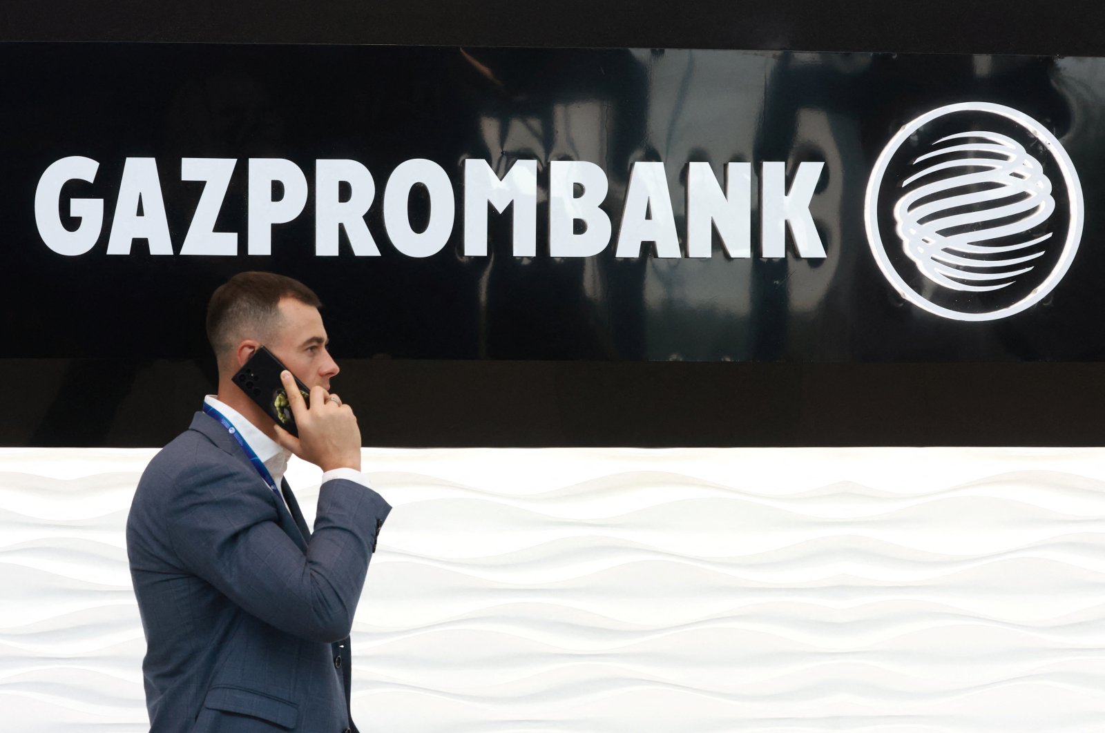 A man walks past the logo of Gazprombank during the Saint Petersburg International Gas Forum in Saint Petersburg, Russia, Sept. 15, 2022. (Reuters File Photo)