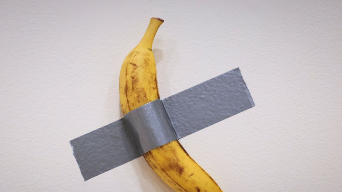 Italian visual artist Maurizio Cattelan&#039;s duct-taped Banana entitled &quot;Comedian&quot; is on display during a media preview at Sotheby&#039;s in New York, U.S., Nov. 8, 2024. (AFP Photo)