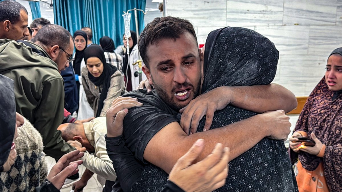 People comfort each other inside the Kamal Adwan hospital, as victims receive medical care following an Israeli strike that hit an area near the medical establishment, Beit Layia, Gaza Strip, Palestine, Nov. 21, 2024. (AFP Photo)