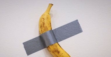 Italian visual artist Maurizio Cattelan&#039;s duct-taped Banana entitled &quot;Comedian&quot; is on display during a media preview at Sotheby&#039;s in New York, U.S., Nov. 8, 2024. (AFP Photo)