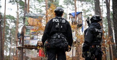 German police officers prepare to clear a protest camp where activists set up tree houses in a forest to protest against the expansion of the Tesla Gigafactory in Gruenheide near Berlin, Germany, Nov. 19, 2024. (Reuters Photo)