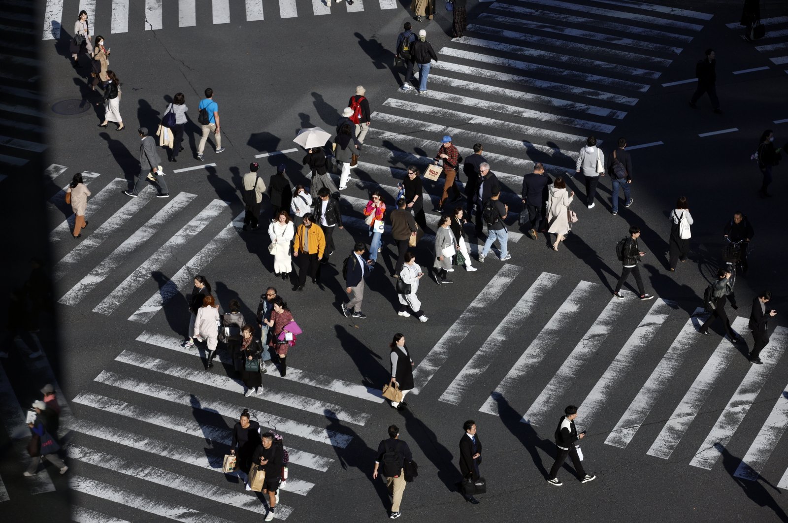 People walk through a crossing at Ginza shopping district, Tokyo, Japan, Nov. 22, 2024. (EPA Photo)