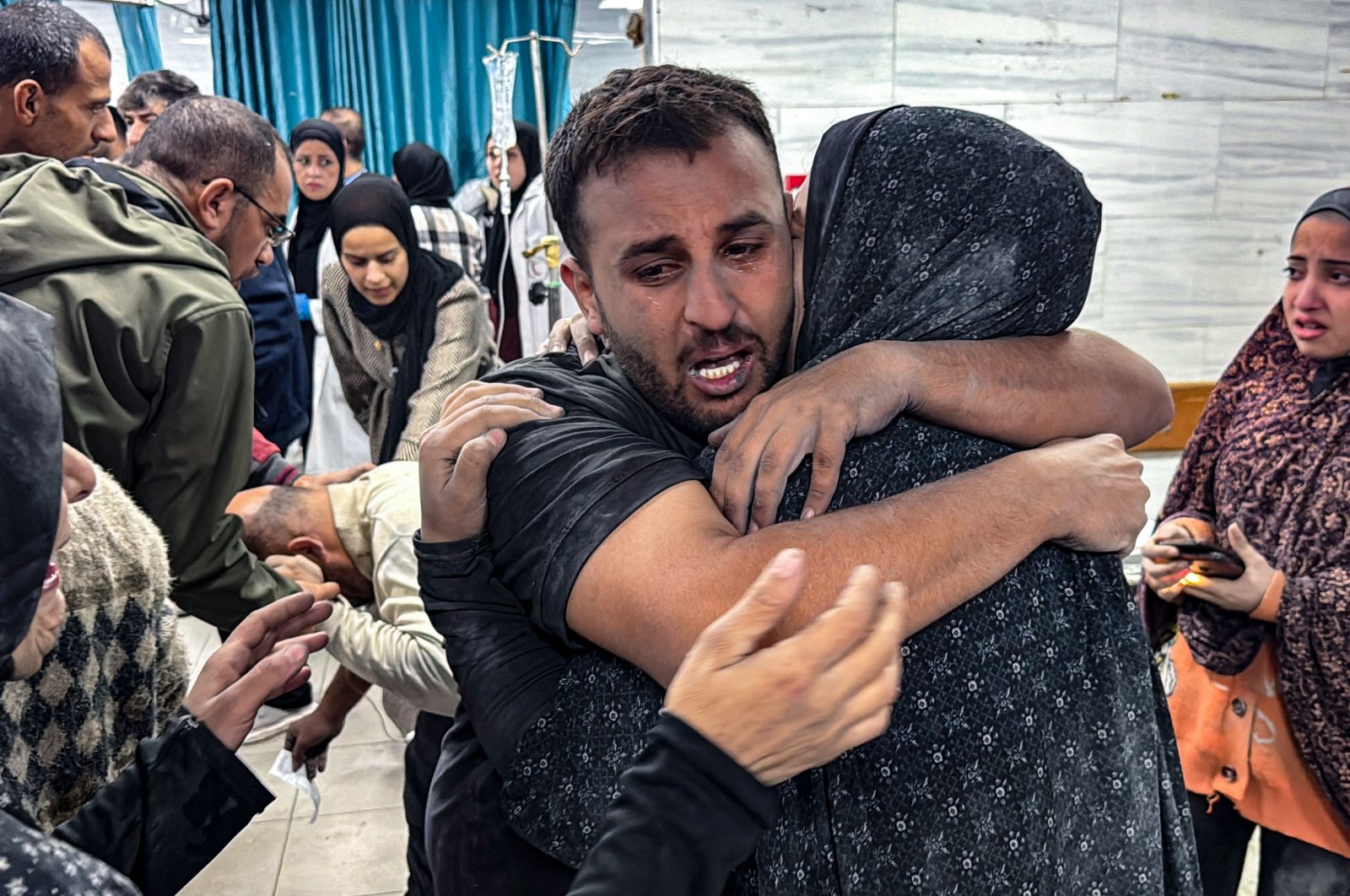 People comfort each other inside the Kamal Adwan hospital, as victims receive medical care following an Israeli strike that hit an area near the medical establishment, Beit Layia, Gaza Strip, Palestine, Nov. 21, 2024. (AFP Photo)