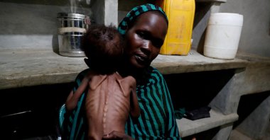 Robaika Peter, 25, holds her severely malnourished child at the pediatric ward of the Mother of Mercy Hospital in Gidel, South Kordofan, Sudan, June 25, 2024. (Reuters Photo)