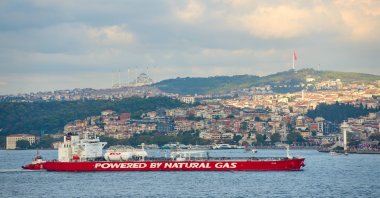 A large red tanker labeled "Powered by Natural Gas" sails through the Bosporus in Istanbul, Türkiye, Sept. 2, 2024. (Reuters Photo)