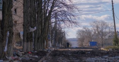 A local resident walks along a damaged street in the town of Siversk, Donetsk region, Ukraine, March 5, 2023. (Reuters Photo)