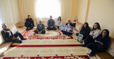 Members of the Boz and Aykut families hold photos of their loved ones killed by the PKK as they mourn in Hakkari, southeastern Türkiye, Nov. 23, 2024. (AA Photo)