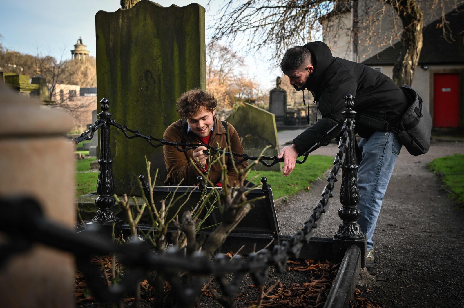 Invisible Cities guide Sonny Murray (R) leads a walking tour with student Arthur Lyhne-Gold in Canongate Kirk, Edinburgh, Scotland, U.K., Nov. 17, 2024. (AFP Photo)