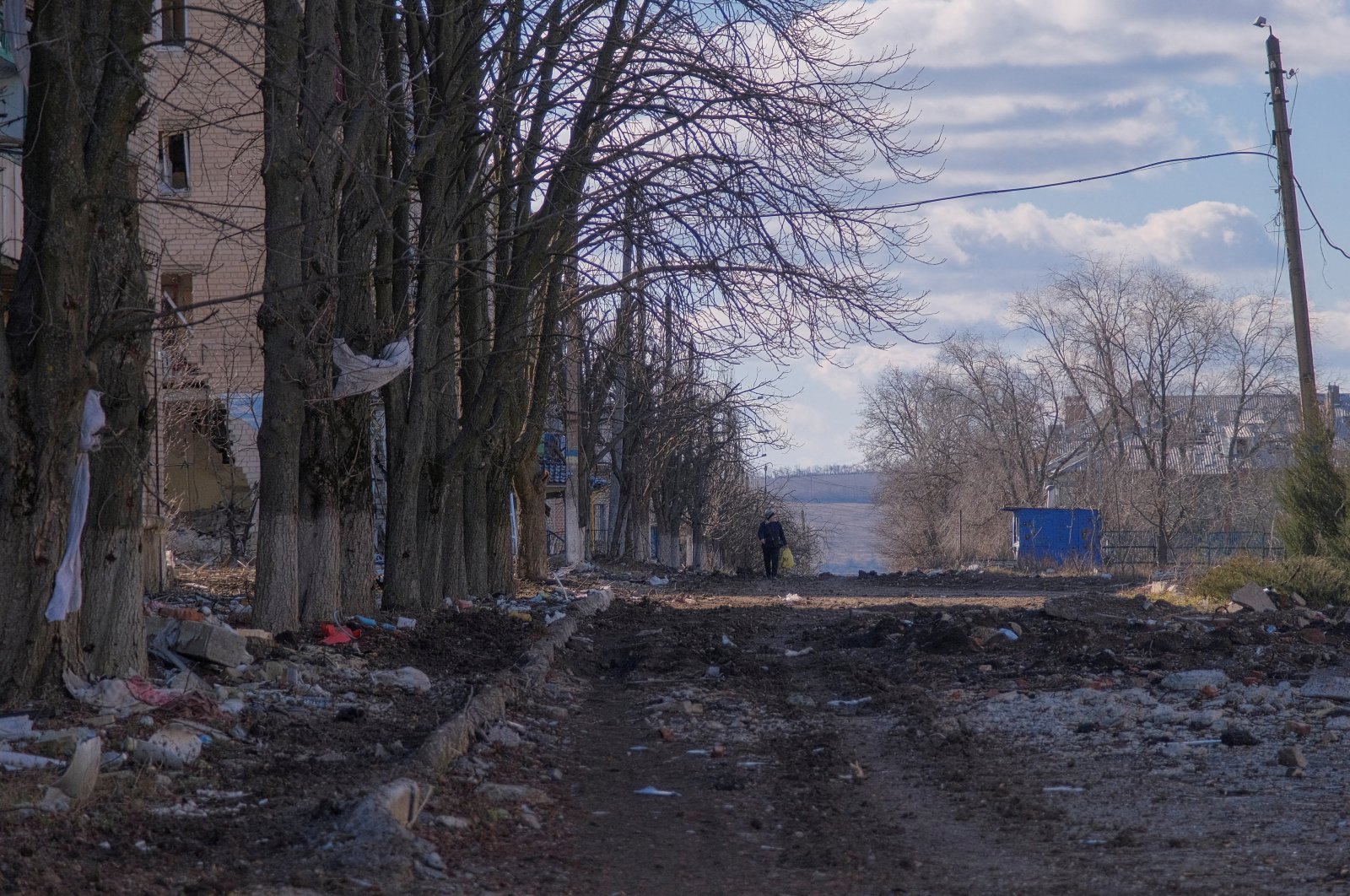 A local resident walks along a damaged street in the town of Siversk, Donetsk region, Ukraine, March 5, 2023. (Reuters Photo)