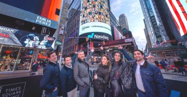 Hande Çilingir (C), co-founder and CEO of Insider, and other Insider team members pose in front of the Nasdaq digital billboard in Times Square in New York, U.S. (Photo: @HandeCilingir)