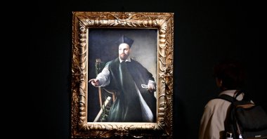 A visitor looks at the private collection and never previously shown to the public painting &quot;Portrait de Maffeo Barberini&quot; by Italian master Caravaggio at the Gallerie Nazionali di Arte Antica in the Barberini palace in Rome, Italy, Nov. 22, 2024. (AFP Photo)