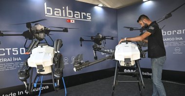A person is photographed next to the UAVs produced by Baibars Mechatronics Aviation, Türkiye, Nov. 24, 2024. (AA Photo)