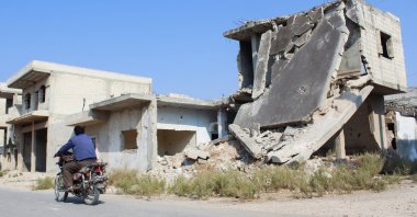 A man rides a motorbike past a damaged building in Homs, Syria Nov. 7, 2024. (Reuters File Photo)