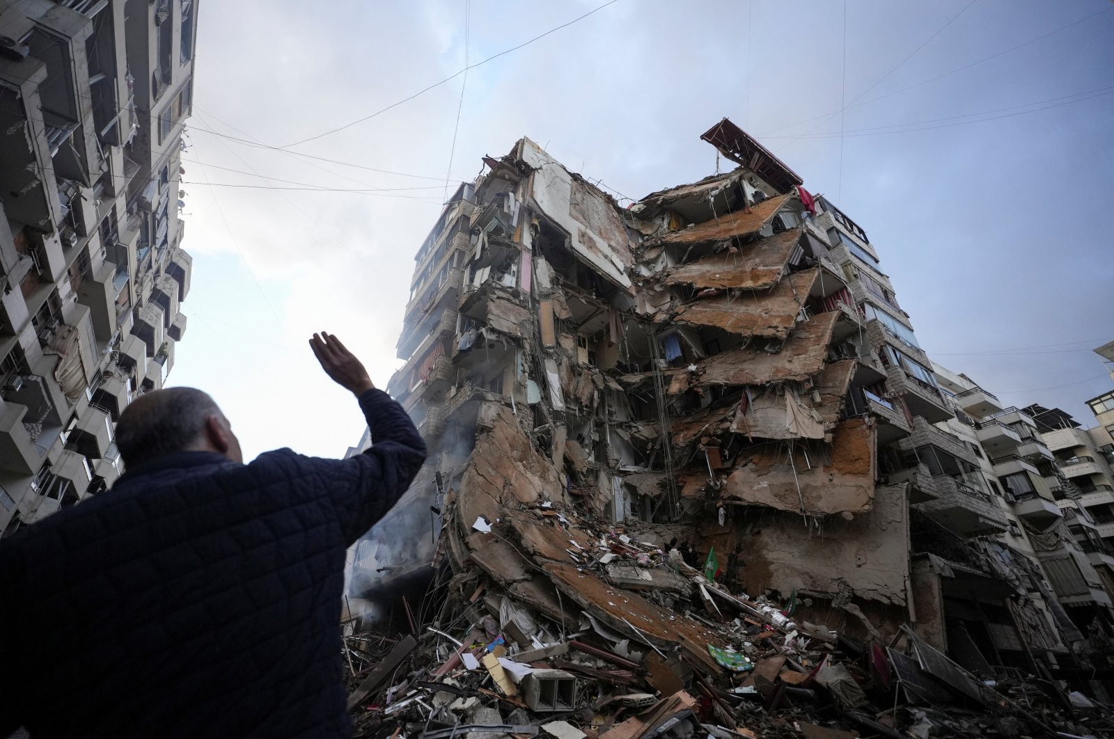 A man gestures near a building destroyed by Israeli airstrikes on Beirut&#039;s southern suburbs, Lebanon, Nov. 25, 2024. (Reuters Photo)