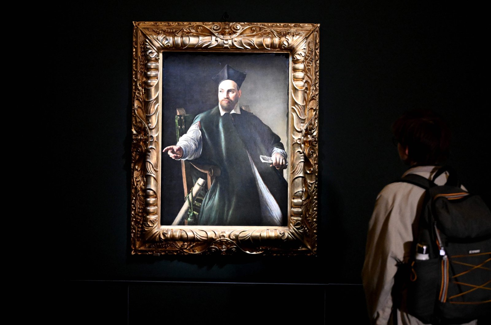 A visitor looks at the private collection and never previously shown to the public painting &quot;Portrait de Maffeo Barberini&quot; by Italian master Caravaggio at the Gallerie Nazionali di Arte Antica in the Barberini palace in Rome, Italy, Nov. 22, 2024. (AFP Photo)