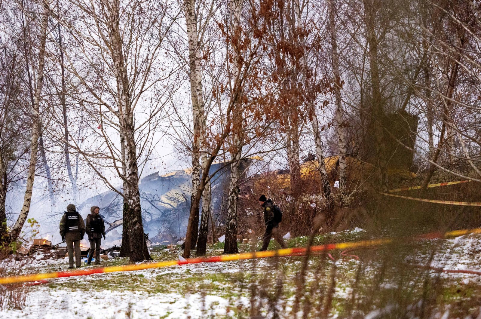 Rescuers work near the wreckage of the DHL cargo plane at the crash site near Vilnius International Airport, Lithuania, Nov. 25, 2024. (Reuters Photo)