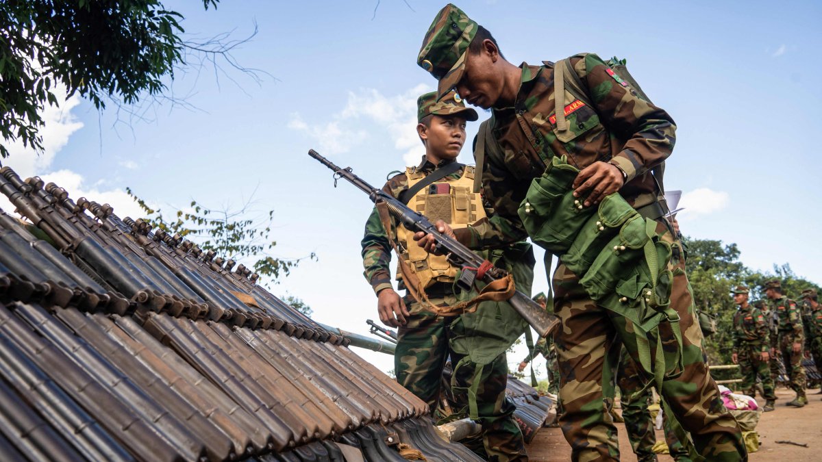 Ta&#039;ang National Liberation Army (TNLA) members receive military equipment at a graduation ceremony after special combat training, near Namhkam, Myanmar, Nov. 9, 2024. (AFP Photo)