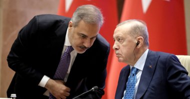 President Recep Tayyip Erdoğan speaks with Foreign Minister Hakan Fidan during a bilateral meeting with the president of Kyrgyzstan, Bishkek, Kyrgyzstan, Nov. 5, 2024. (EPA Photo)