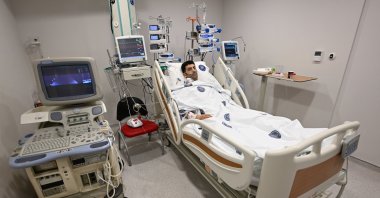 Recipient Mehmet Yıldırım, 32, lies on a hospital bed after undergoing heart transplant surgery in Antalya, southern Türkiye, Nov. 25, 2024. (AA Photo)