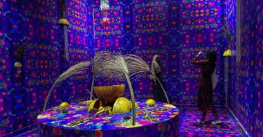 A visitor takes pictures of artworks at the Dakar Biennale, Senegal, Nov. 19, 2024. (AA Photo)