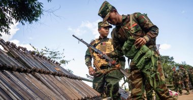 Ta'ang National Liberation Army (TNLA) members receive military equipment at a graduation ceremony after special combat training, near Namhkam, Myanmar, Nov. 9, 2024. (AFP Photo)