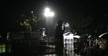 An Ultra-Orthodox Jewish Rabbi speaks beside the coffin of murdered Rabbi Zvi Kogan as rain falls during his funeral ceremony, in Kfar Chabad, near Tel Aviv, Israel,  Nov. 25, 2024. (EPA Photo)