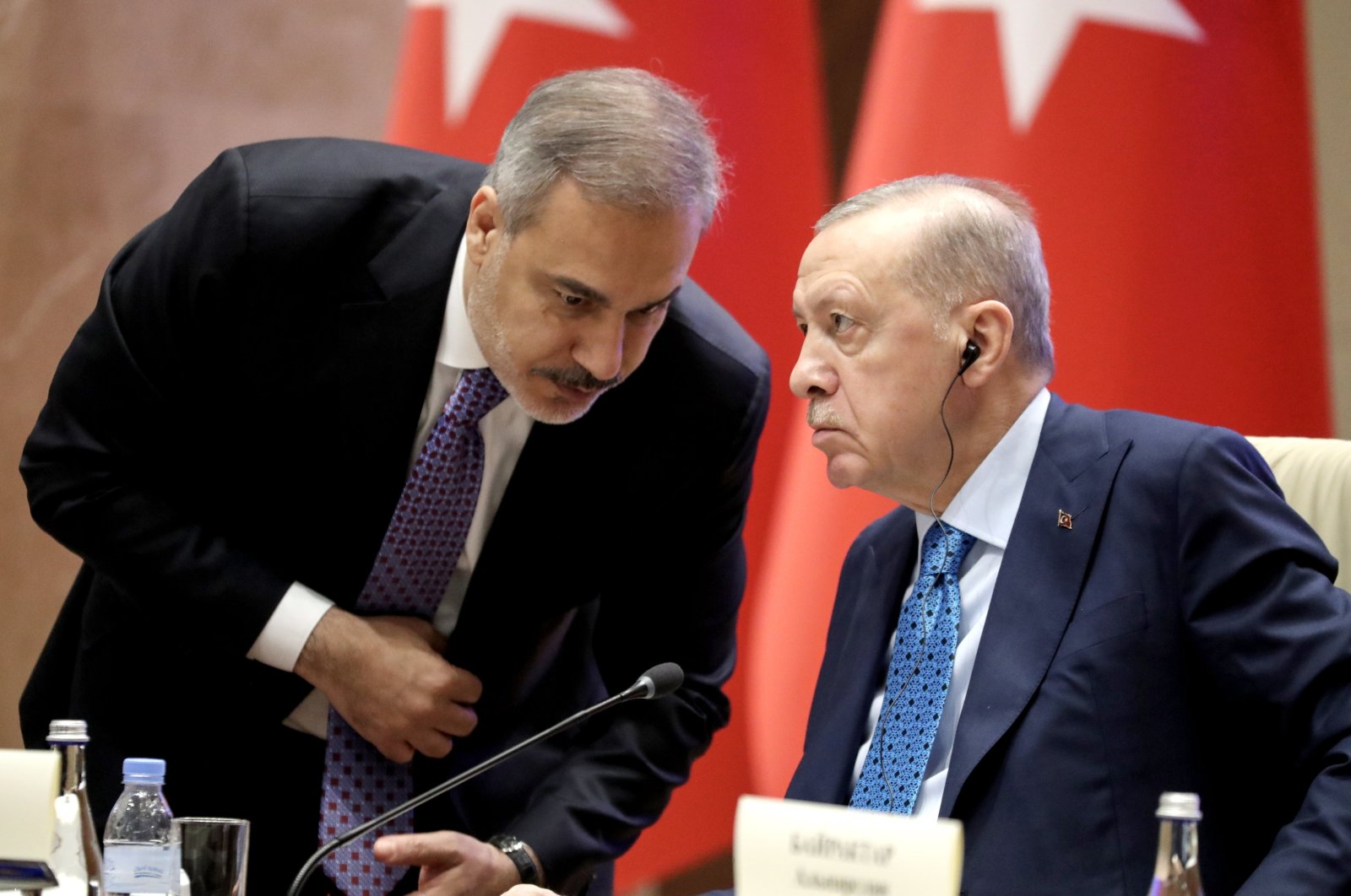 President Recep Tayyip Erdoğan speaks with Foreign Minister Hakan Fidan during a bilateral meeting with the president of Kyrgyzstan, Bishkek, Kyrgyzstan, Nov. 5, 2024. (EPA Photo)