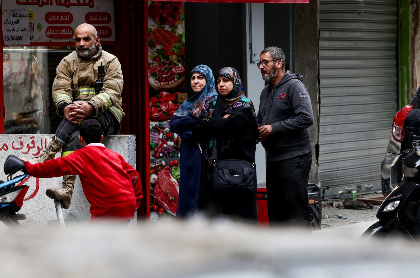 A civil defense member and people stand near a damaged site in the aftermath of Israeli strikes, Beirut, Lebanon, Nov. 25, 2024. (Reuters Photo)