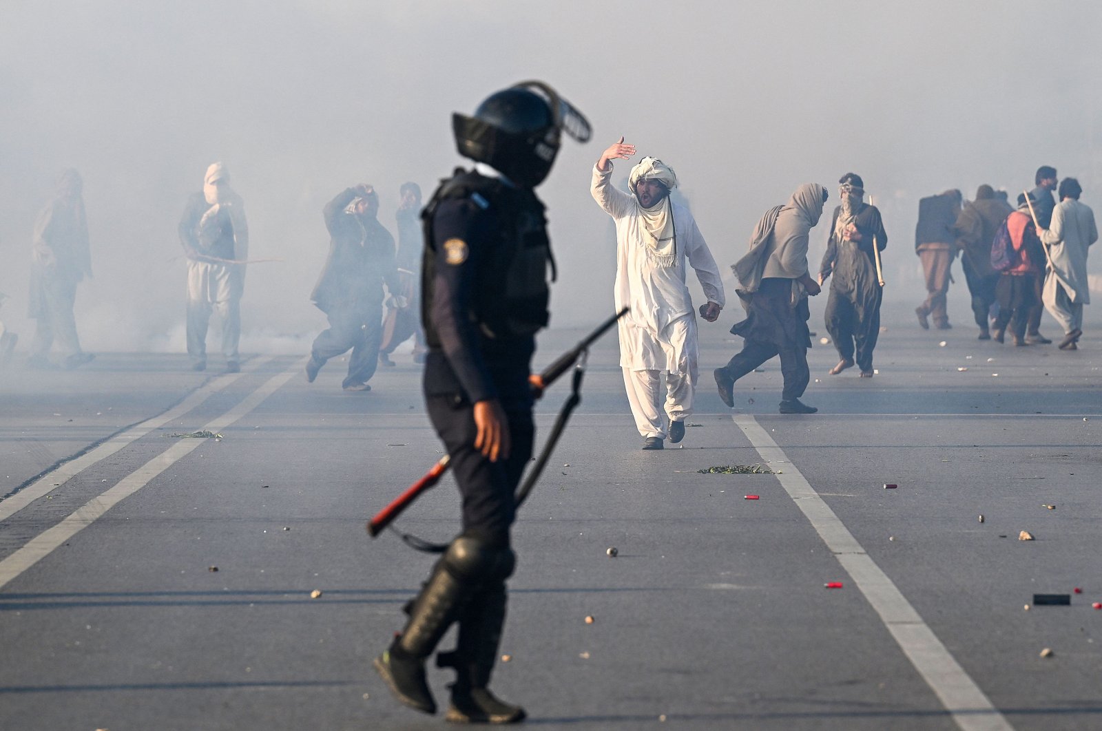 Policemen fire tear gas shells to disperse supporters of the Pakistan Tehreek-e-Insaf (PTI) party during a protest to demand the release of former prime minister Imran Khan, in Islamabad, Pakistan, Nov. 26, 2024. (AFP Photo)