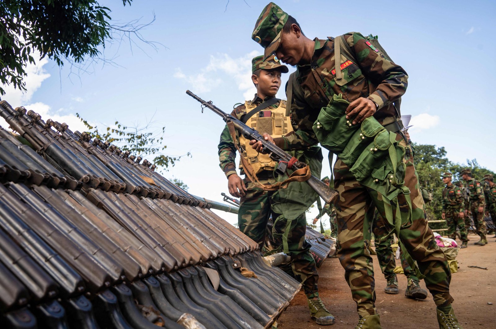 Ta&#039;ang National Liberation Army (TNLA) members receive military equipment at a graduation ceremony after special combat training, near Namhkam, Myanmar, Nov. 9, 2024. (AFP Photo)