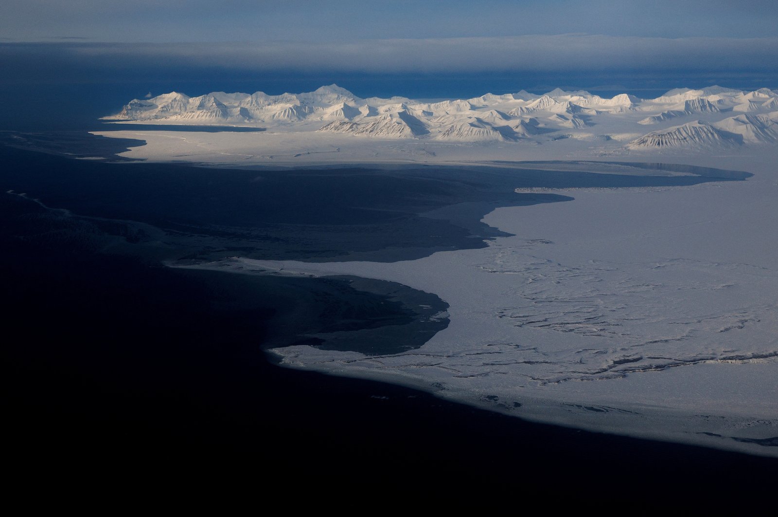 A general view of snowcapped mountains and the Arctic Ocean on the coast of Svalbard near Longyearbyen, Norway, April 5, 2023. (Reuters Photo)