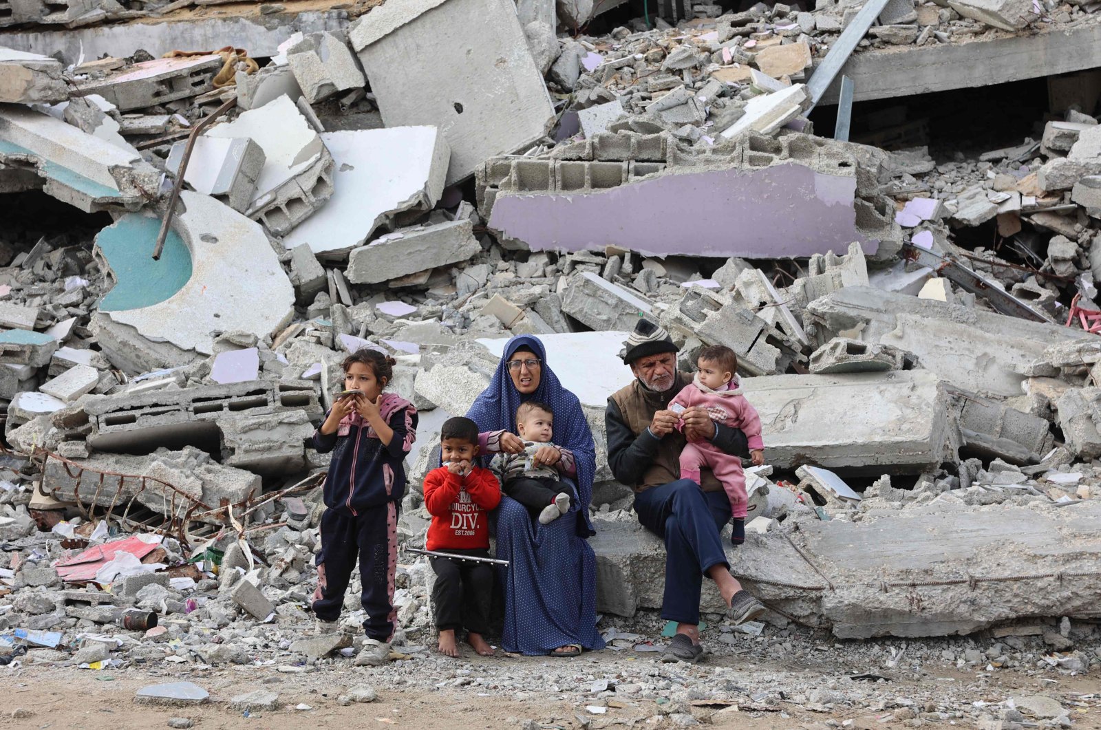 A Palestinian family rests on the rubble of a building west of Gaza City, Gaza, Palestine, Nov. 25, 2024. (AFP Photo)